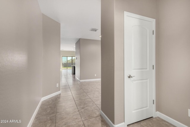 hall featuring light tile patterned flooring