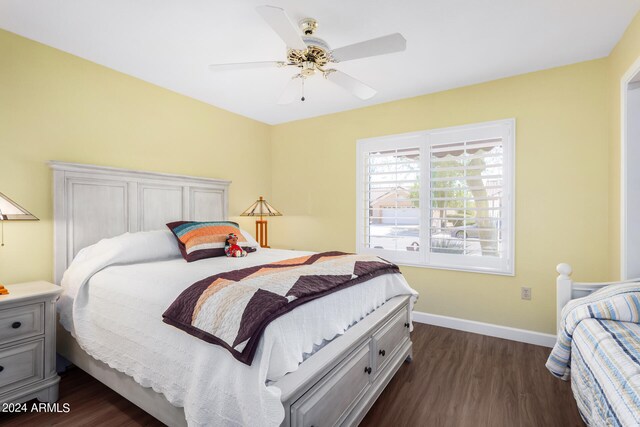 bedroom featuring ceiling fan and dark wood-type flooring