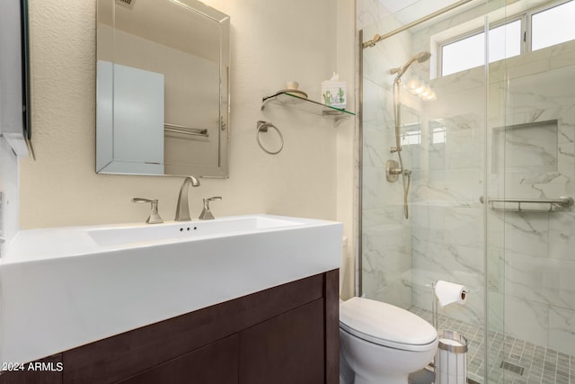 bathroom featuring walk in shower, vanity, and toilet