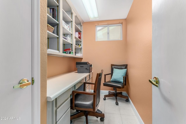 office featuring built in desk and light tile patterned floors