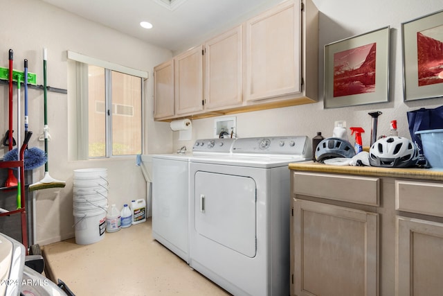 washroom with washing machine and dryer and cabinets