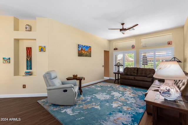 living room featuring ceiling fan and dark hardwood / wood-style flooring