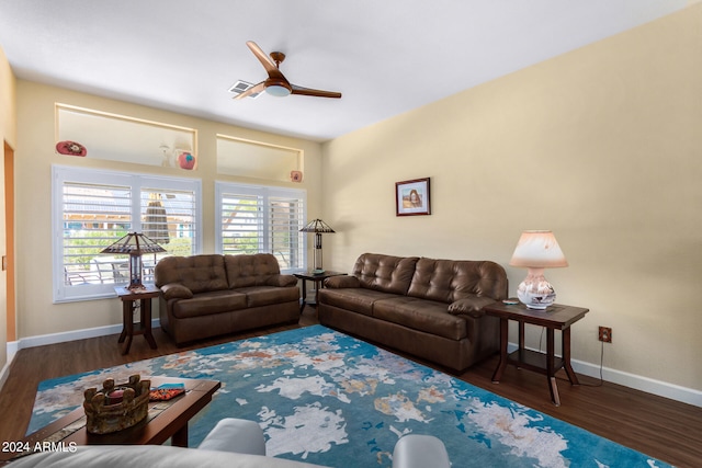 living room with ceiling fan and dark wood-type flooring