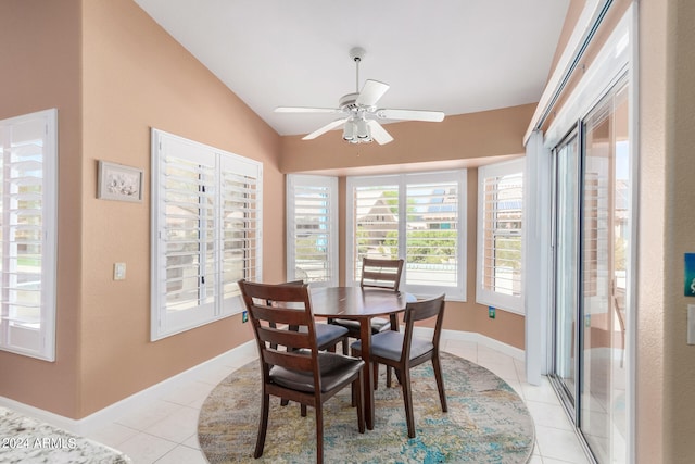 tiled dining space with vaulted ceiling and ceiling fan