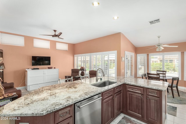 kitchen featuring ceiling fan, light stone counters, sink, a center island with sink, and dishwasher