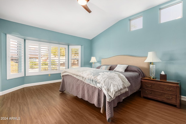 bedroom featuring ceiling fan, dark hardwood / wood-style floors, and multiple windows