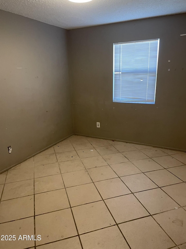 unfurnished room featuring a textured ceiling