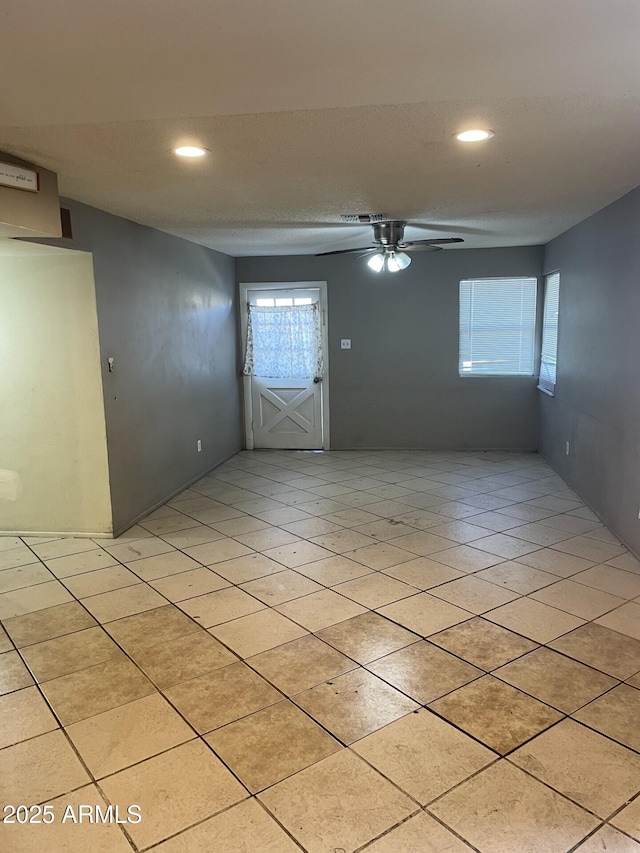 unfurnished room with light tile patterned floors, a ceiling fan, and recessed lighting