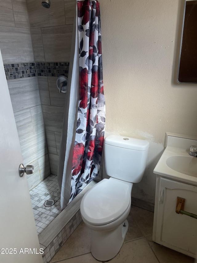 bathroom with toilet, a shower stall, and vanity