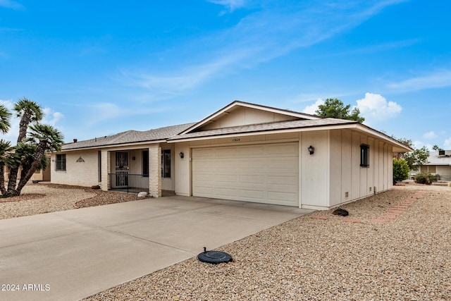 single story home with a porch and a garage