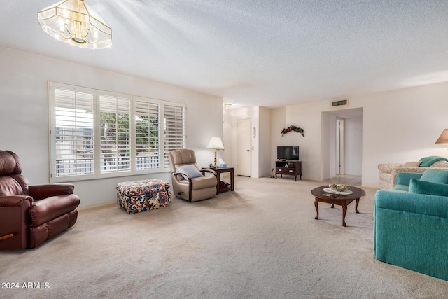 carpeted living room featuring a textured ceiling and an inviting chandelier