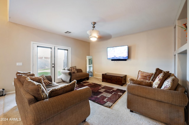 living room featuring french doors, ceiling fan, and light carpet