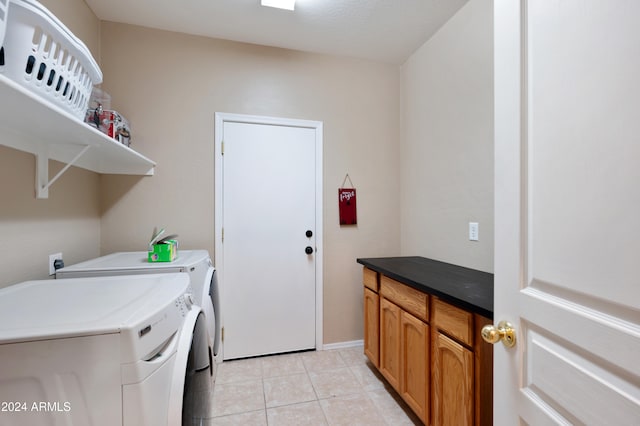 laundry room with washer and clothes dryer and light tile patterned flooring