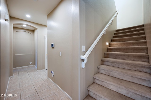 stairs featuring tile patterned flooring