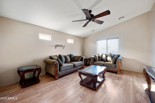 living room featuring ceiling fan, vaulted ceiling, and light hardwood / wood-style floors