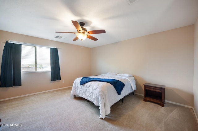 bedroom featuring light carpet and ceiling fan