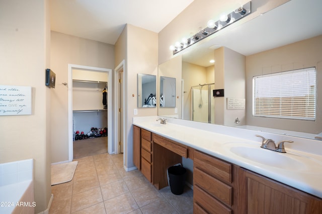 bathroom with tile patterned flooring, plus walk in shower, and vanity