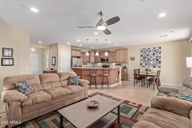 tiled living room with ceiling fan