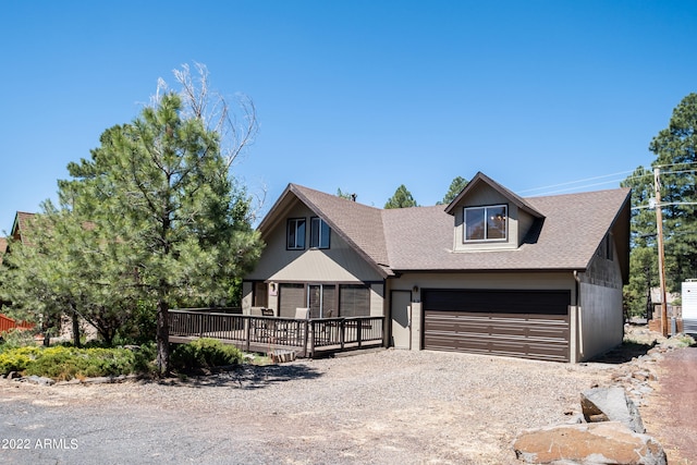 view of front facade featuring a garage and a wooden deck