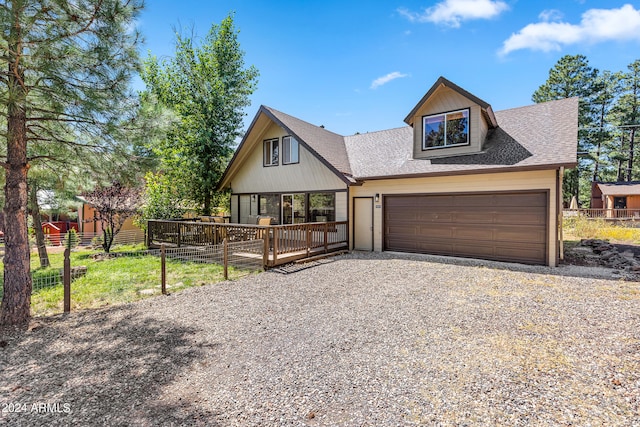 view of front of property with a wooden deck and a garage