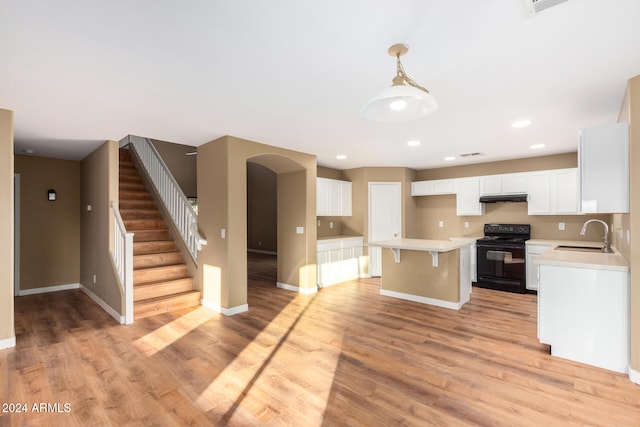 kitchen featuring sink, a center island, hanging light fixtures, black / electric stove, and light wood-type flooring