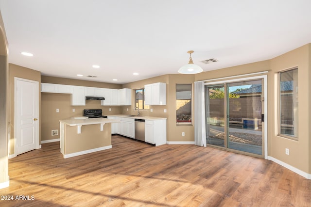 kitchen with black stove, sink, decorative light fixtures, a center island, and white cabinetry