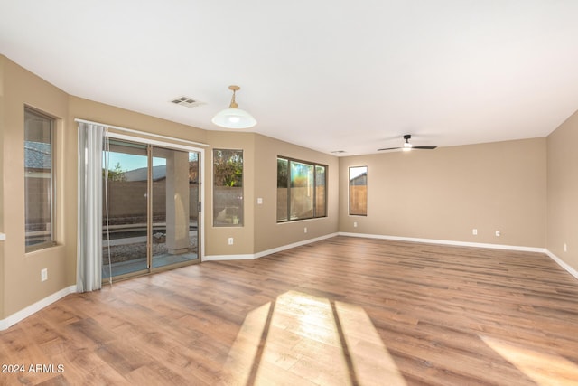 unfurnished living room with ceiling fan and light hardwood / wood-style floors