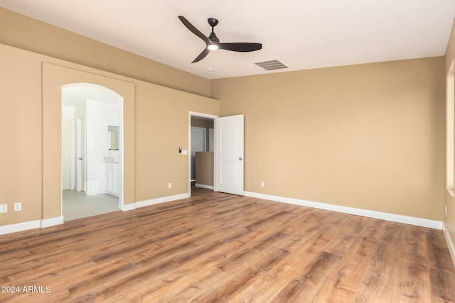 unfurnished bedroom with ensuite bath, ceiling fan, and light hardwood / wood-style flooring