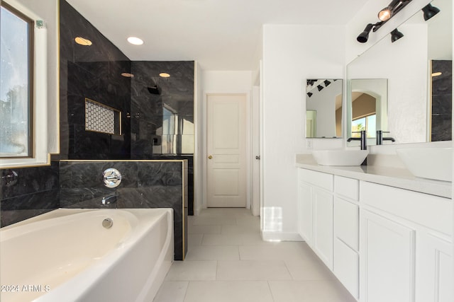 bathroom with tile patterned flooring, vanity, and plus walk in shower