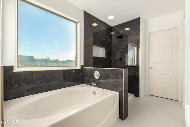 bathroom featuring tile patterned floors and independent shower and bath