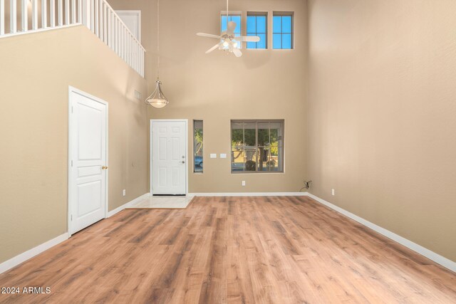 entrance foyer featuring plenty of natural light, light hardwood / wood-style floors, and a high ceiling