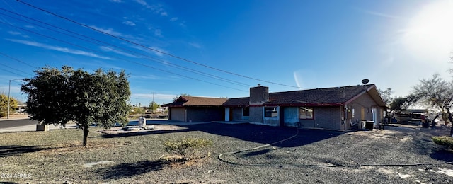 view of side of property featuring cooling unit and a garage