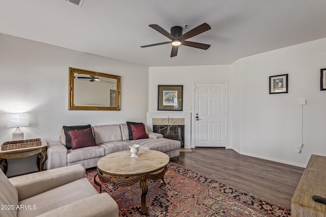 9450 E Becker Ln Unit 1046, Scottsdale, AZ 85260 - living room featuring a ceiling fan, wood finished floors, baseboards, and a high end fireplace