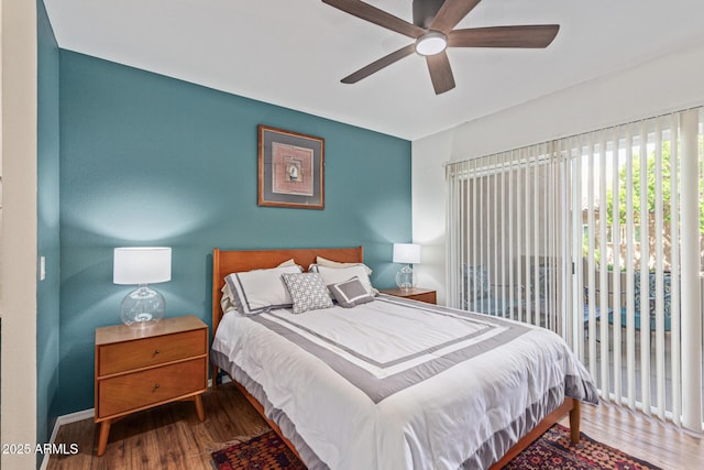 9450 E Becker Ln Unit 1046, Scottsdale, AZ 85260 - bedroom featuring wood finished floors, access to exterior, baseboards, and ceiling fan