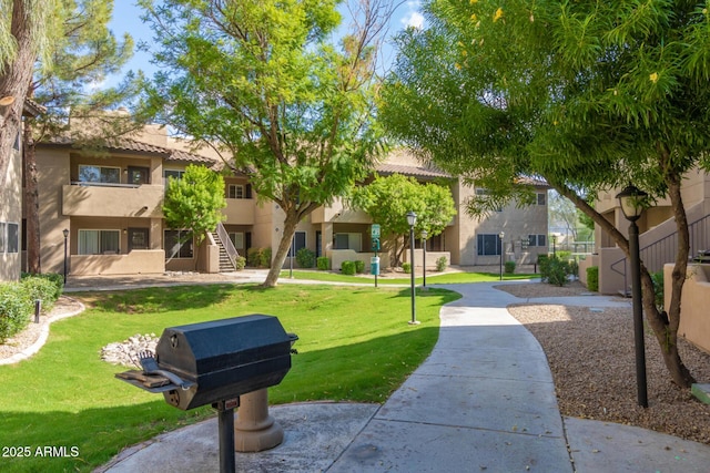 9450 E Becker Ln Unit 1046, Scottsdale, AZ 85260 - view of property's community with a lawn and stairs