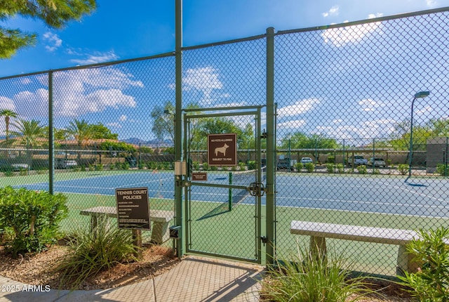 9450 E Becker Ln Unit 1046, Scottsdale, AZ 85260 - view of tennis court with a gate