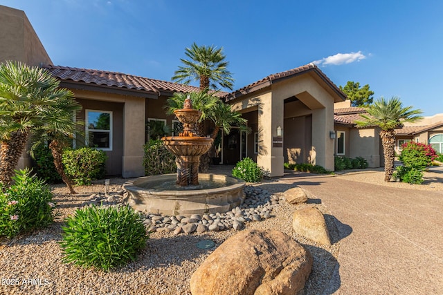9450 E Becker Ln Unit 1046, Scottsdale, AZ 85260 - mediterranean / spanish-style house featuring stucco siding and a tiled roof