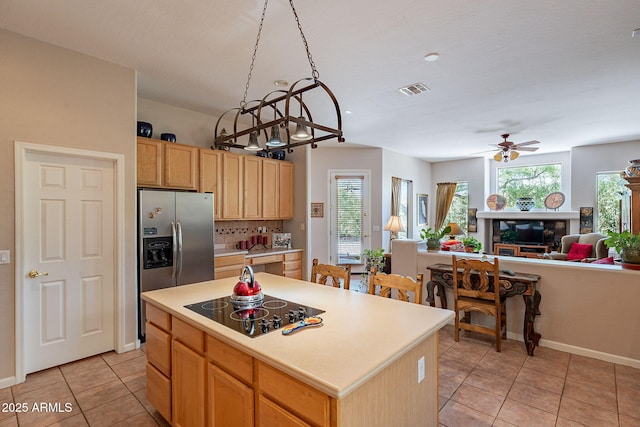 5336 E Gloria Ln, Cave Creek, AZ 85331 - kitchen with black electric stovetop, light tile patterned flooring, a ceiling fan, open floor plan, and a fireplace