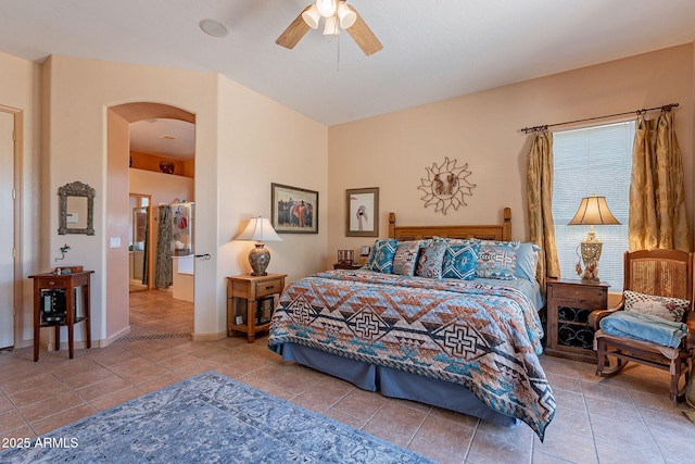 5336 E Gloria Ln, Cave Creek, AZ 85331 - bedroom with arched walkways, tile patterned floors, ceiling fan, and baseboards