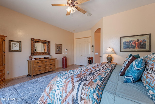 5336 E Gloria Ln, Cave Creek, AZ 85331 - bedroom with tile patterned flooring, arched walkways, and ceiling fan