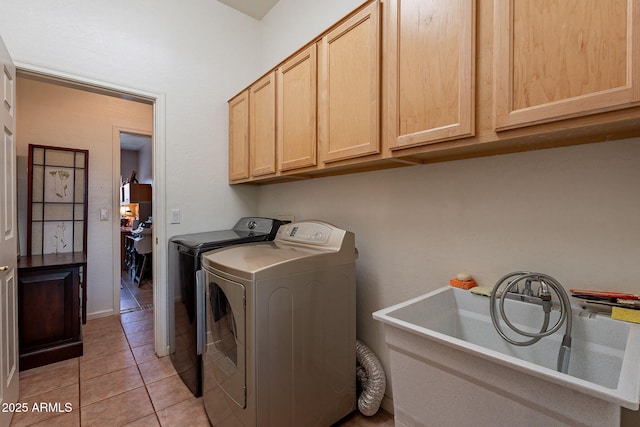 5336 E Gloria Ln, Cave Creek, AZ 85331 - clothes washing area with washing machine and dryer, cabinet space, and light tile patterned floors