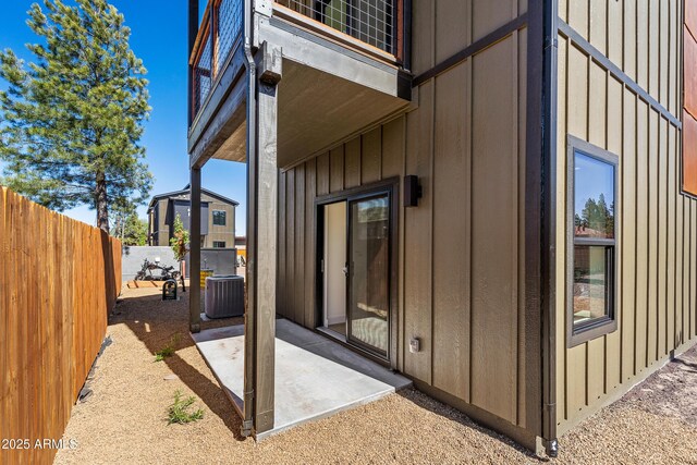 302 W Oak Ave Unit 2, Flagstaff, AZ 86001 - view of home's exterior featuring a patio, cooling unit, and board and batten siding