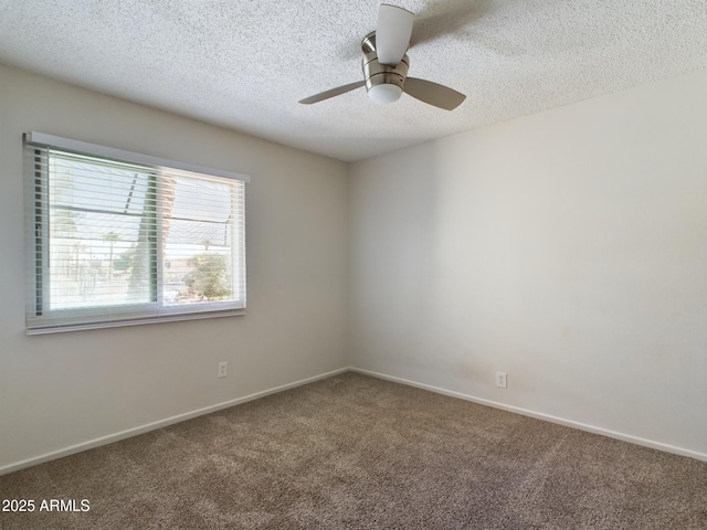 spare room with ceiling fan, carpet, and a textured ceiling