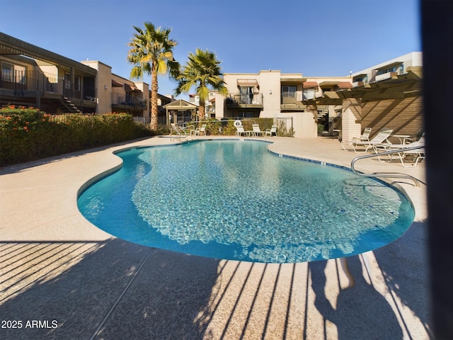 view of pool featuring a pergola and a patio