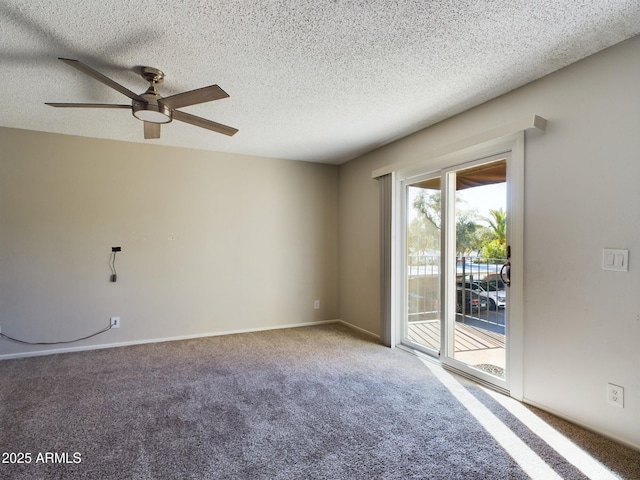 carpeted spare room featuring ceiling fan and a textured ceiling