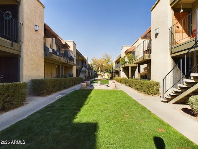 view of property's community with a lawn