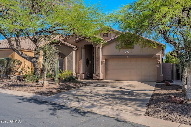 3055 N Red Mtn Unit 122, Mesa, AZ 85207 - view of front of home with stucco siding, an attached garage, concrete driveway, and a tile roof