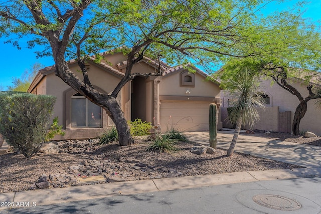 3055 N Red Mtn Unit 122, Mesa, AZ 85207 - view of front facade with driveway, stucco siding, an attached garage, and a tiled roof