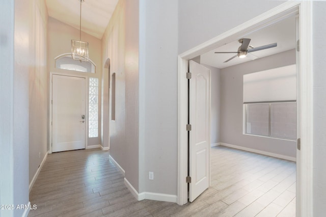 3055 N Red Mtn Unit 122, Mesa, AZ 85207 - foyer with wood finished floors, lofted ceiling, a chandelier, baseboards, and a ceiling fan