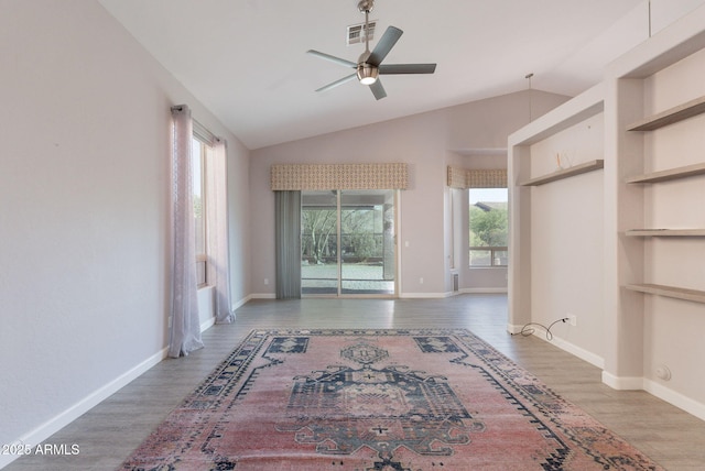 3055 N Red Mtn Unit 122, Mesa, AZ 85207 - empty room with ceiling fan, wood finished floors, built in features, vaulted ceiling, and baseboards